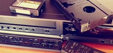 A photo showing various forms of old media, including VHS cassette tapes.