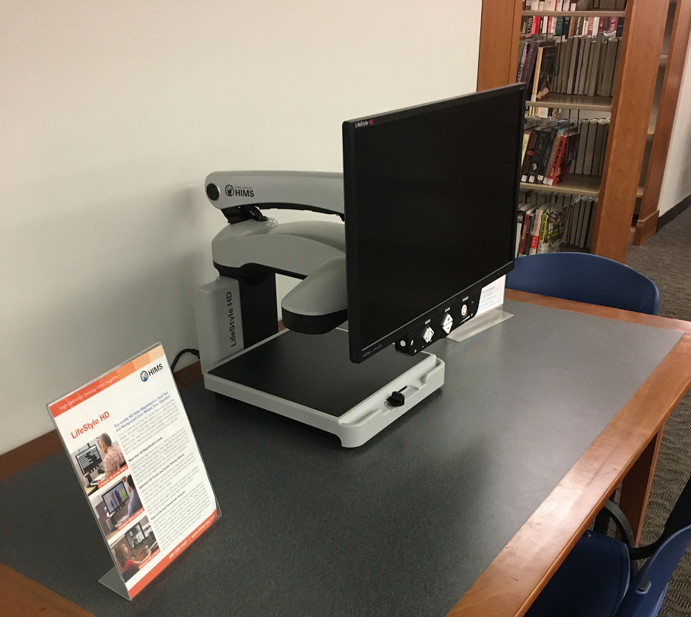 An image of a magnifying device atop a counter at the library.